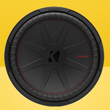 Front view of KICKER CompR 15 inch Subwoofer on two-tone yellow background