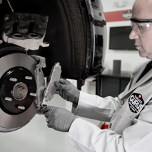 Technician replacing a rotor and brake pad